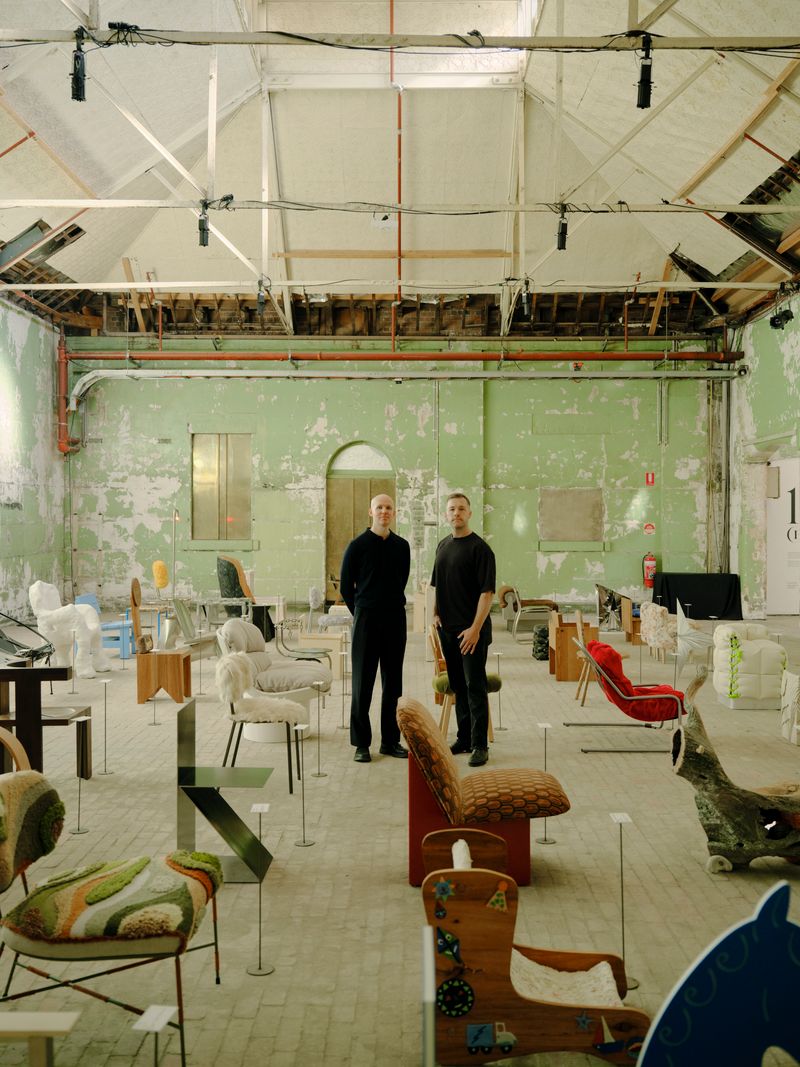 Curators Dale Hardiman and Tom Skeehan at Abbotsford Convent surrounded by handmade Australian designed chairs