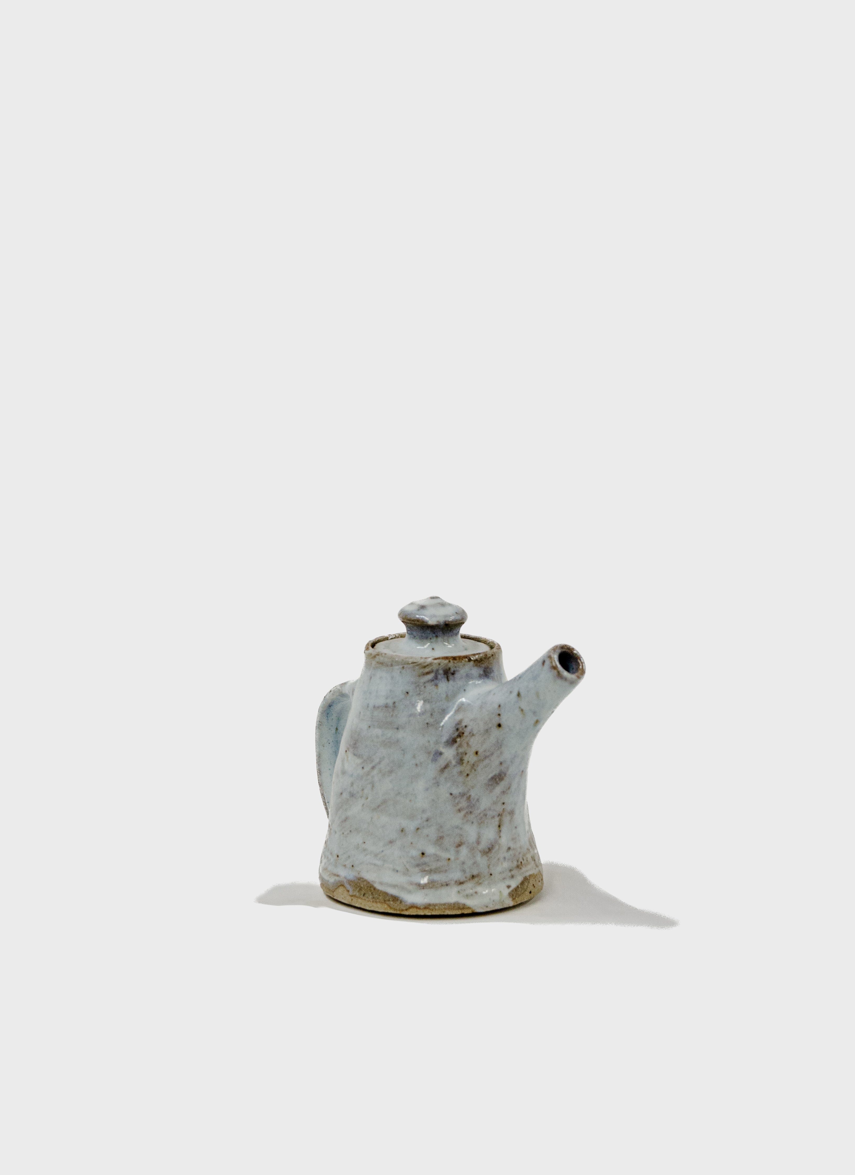 Tall teapot in stoneware clay and porcelain slip decorated with a Nuka style glaze.  Handmade in Sydney by Remy Pajaczkowski-Russell.