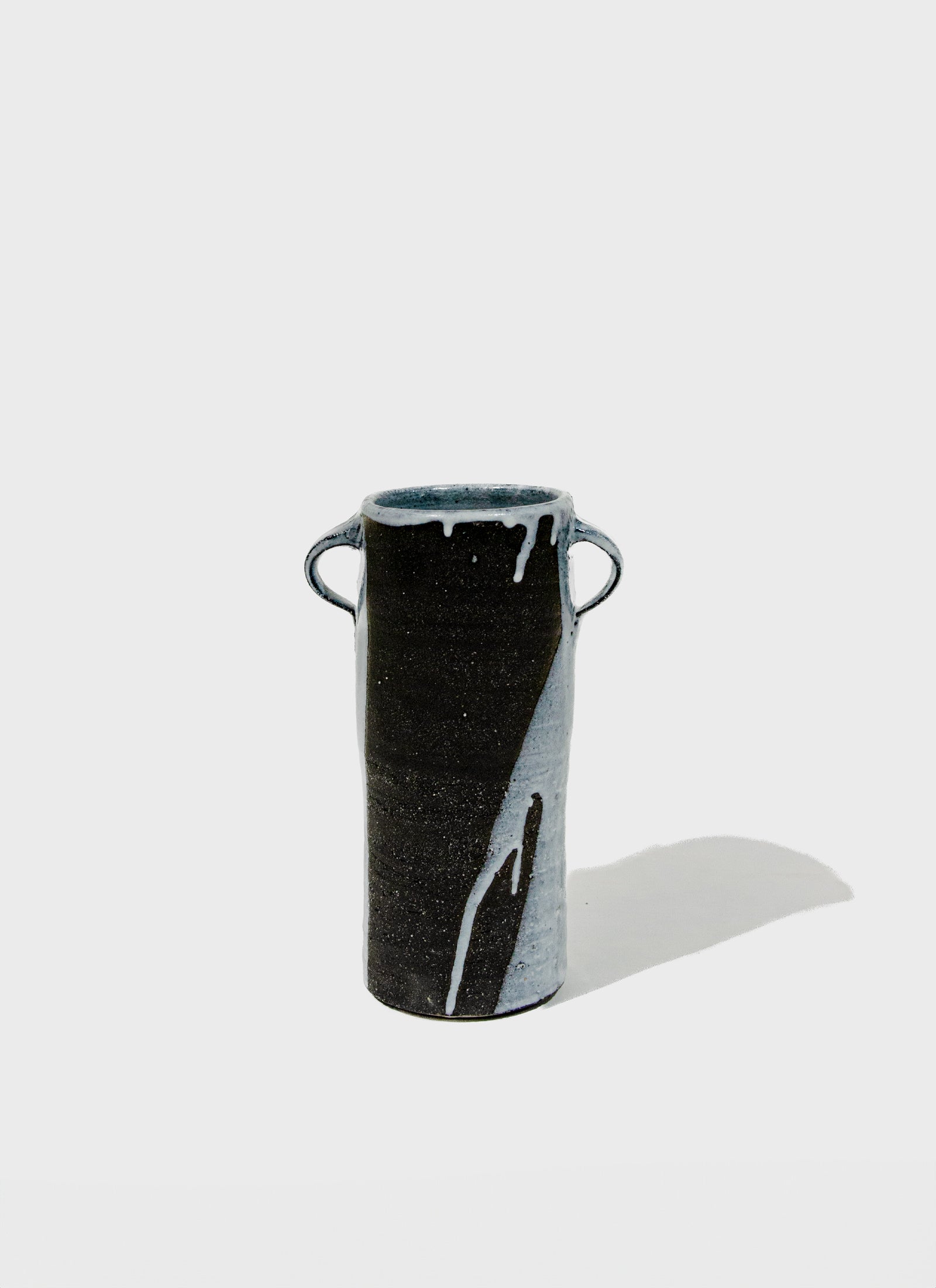 Black and gray ceramic vase on a white background